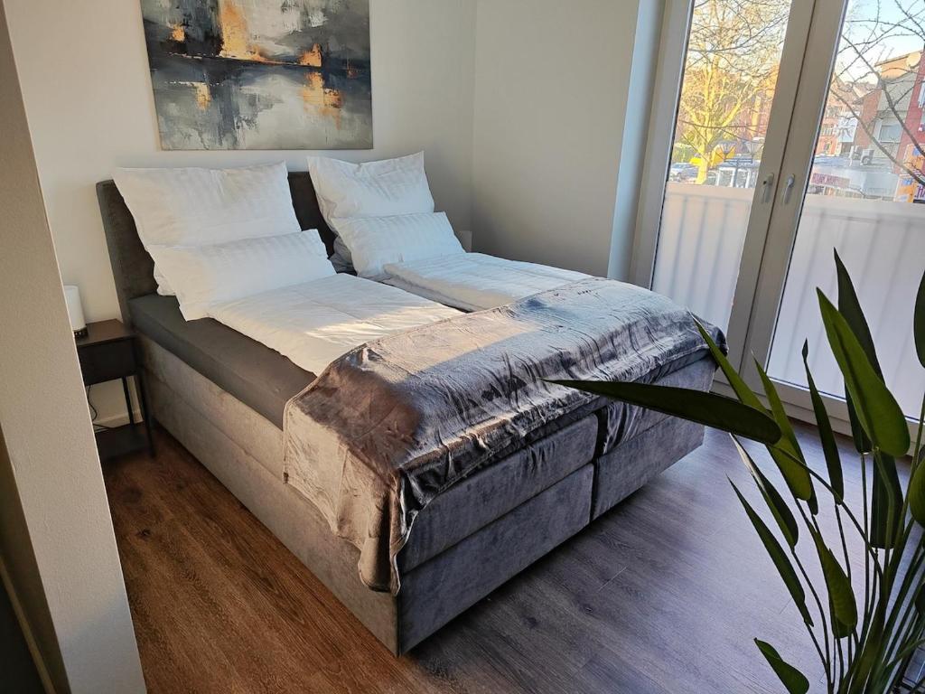 Ένα ή περισσότερα κρεβάτια σε δωμάτιο στο FEEL - Comfort Prinzipal Münster