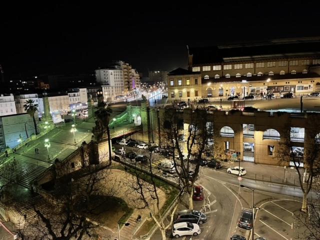 a city at night with cars parked in a parking lot at Lafayette Gare Saint-Charles in Marseille