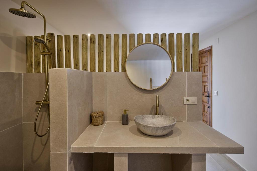 a bathroom with a bowl sink and a mirror at Casa El Sueño in Jávea