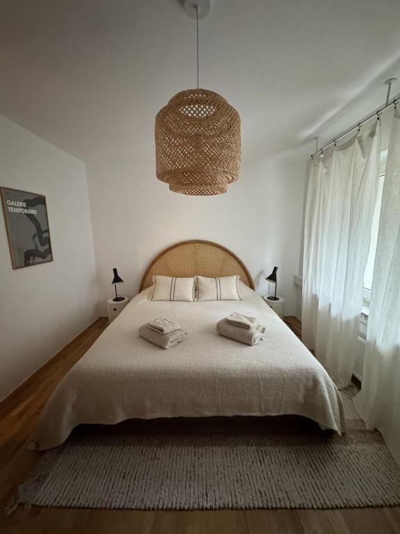 a bedroom with a large bed and a chandelier at Wiembachallee in Leverkusen