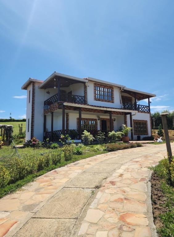 a large white house with a road in front of it at Villa Nikitina in Los Santos