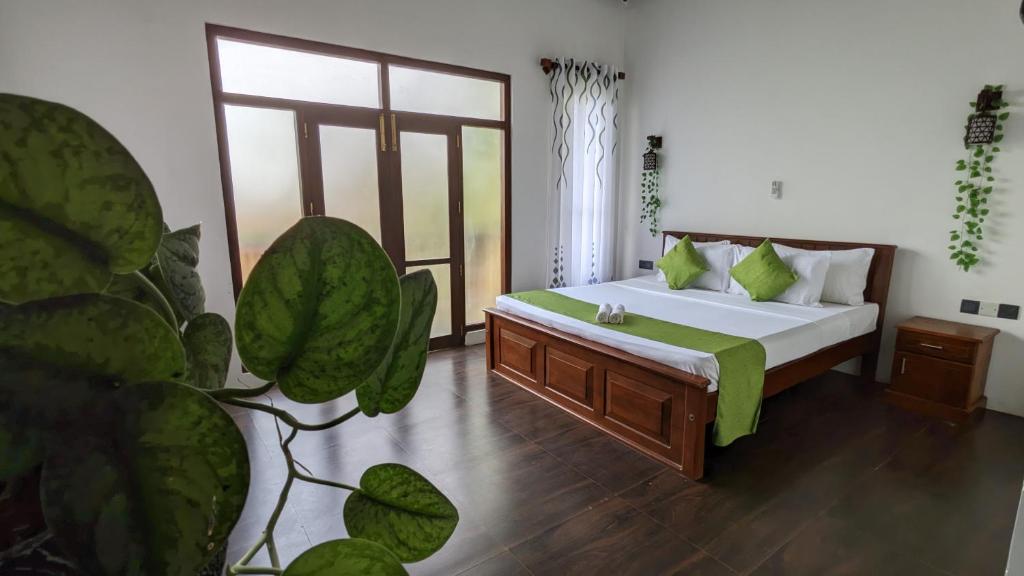 a bedroom with a bed and a large window at Dove nest villa in Tangalle