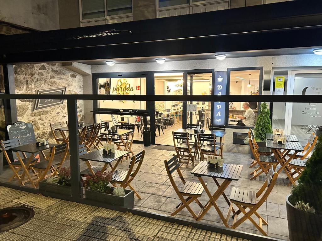 a restaurant with tables and chairs in front of it at HOSTAL CASA JULIO - Auto Check-in in Culleredo