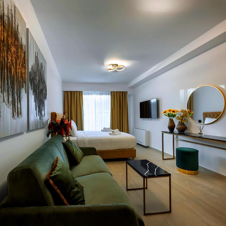 a hotel room with a couch and a bed at Bronze Suites in Ioannina
