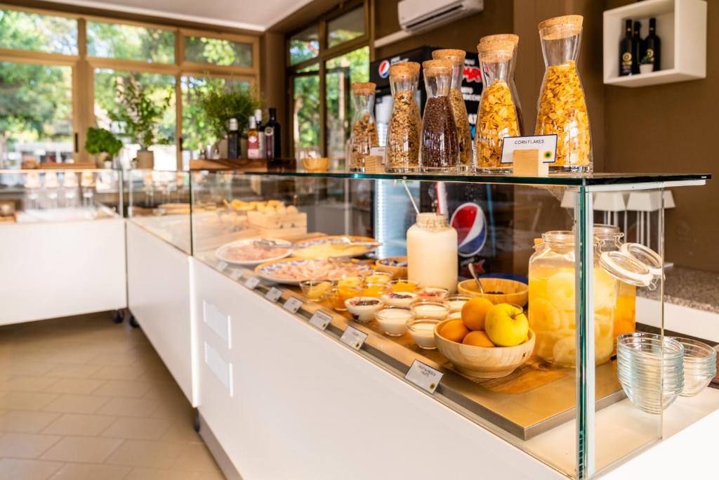 a display case with a lot of food and drinks at Club del Sole Viareggio Family Collection in Torre del Lago Puccini