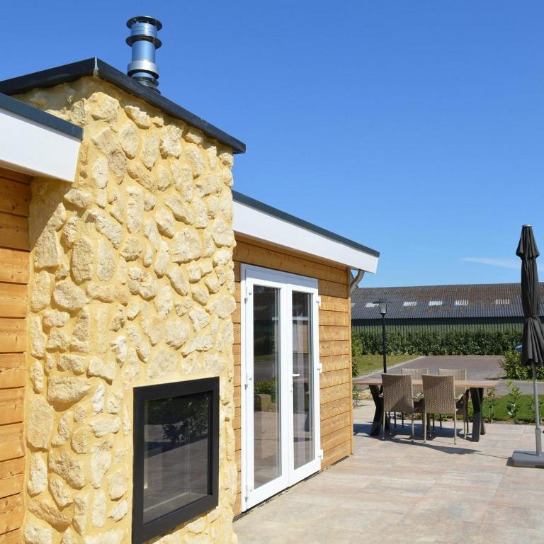 a stone facade of a house with a patio at Schaelsbergerbosch- 2 Bath FireplGarde in Valkenburg