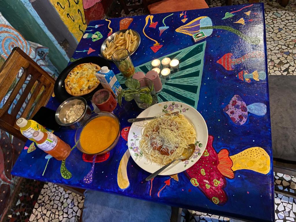 a blue table with a plate of food on it at Bob hostel in Jodhpur