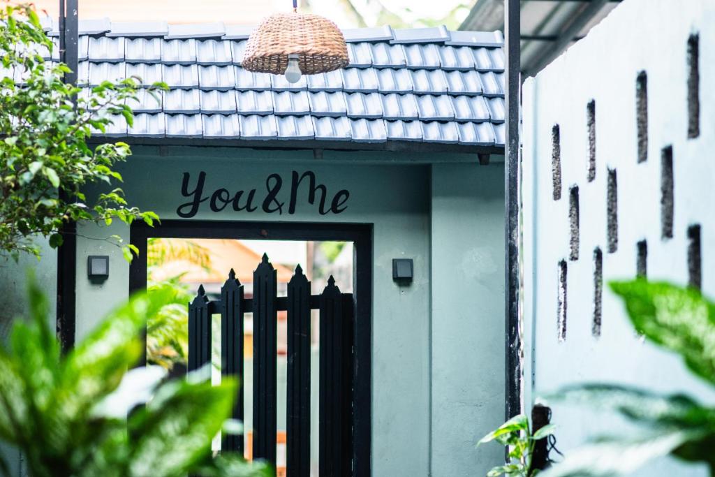 a sign that says you gotta me in front of a building at You and Me in Varkala