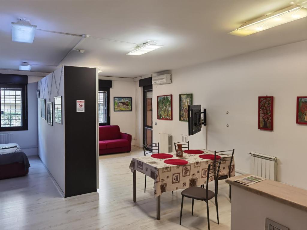 a room with a table and chairs and a couch at Ballarin Studio Apartment for Business Travels and Holidays in Rome