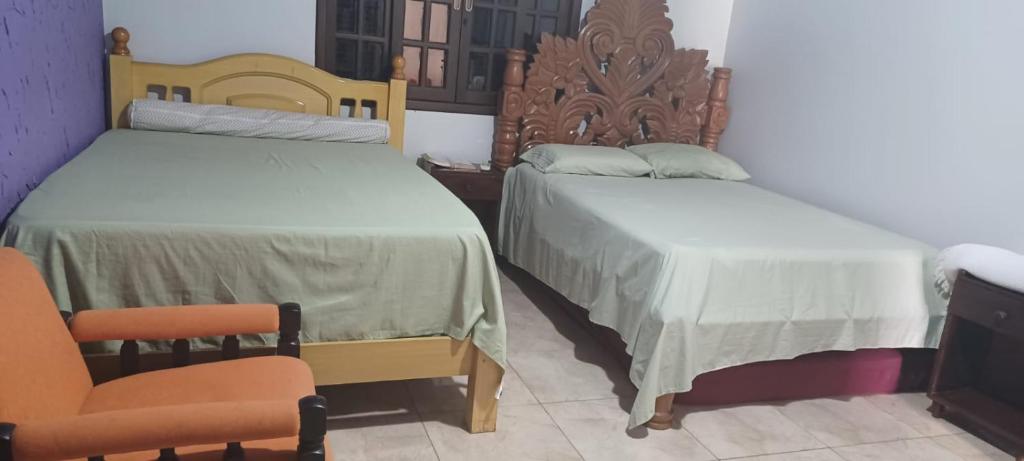 two beds sitting next to each other in a room at Chacara barro branco in Foz do Iguaçu