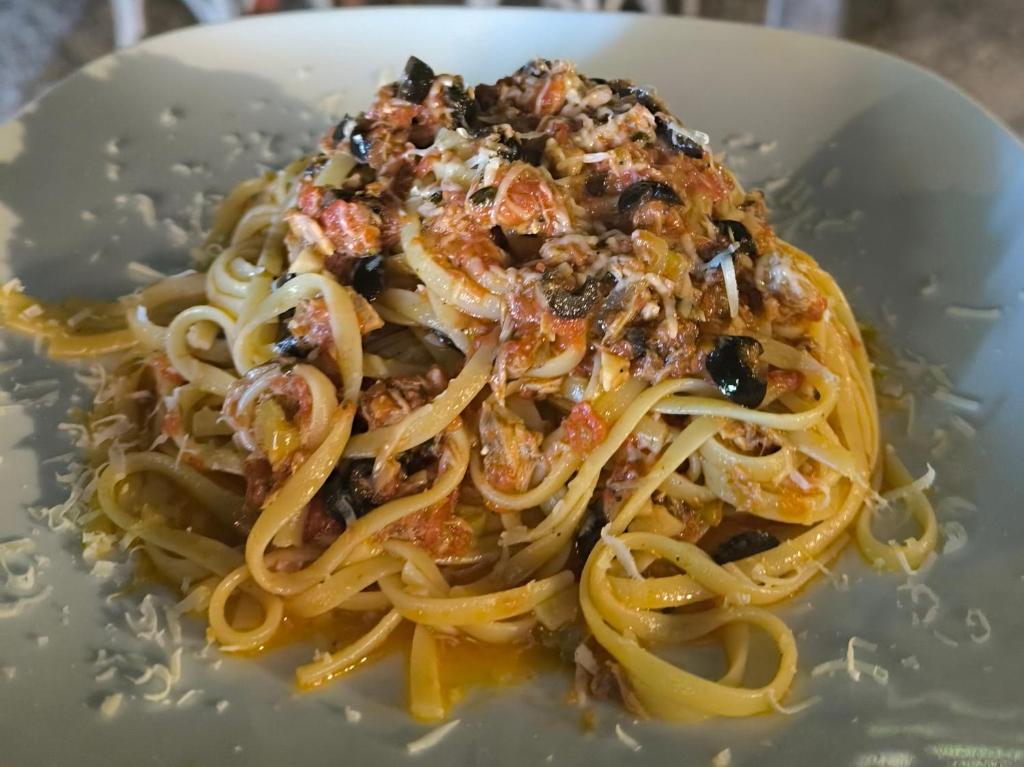 a plate of pasta on a white plate at Litost Cafe in Adrasan