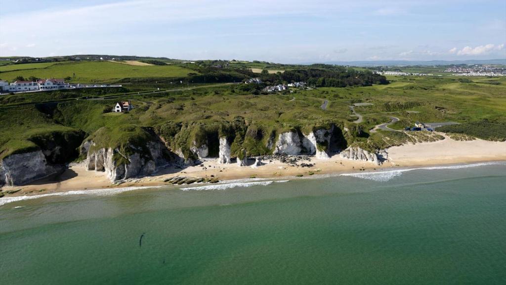 an aerial view of a beach and cliffs at Albany Lodge in Portrush