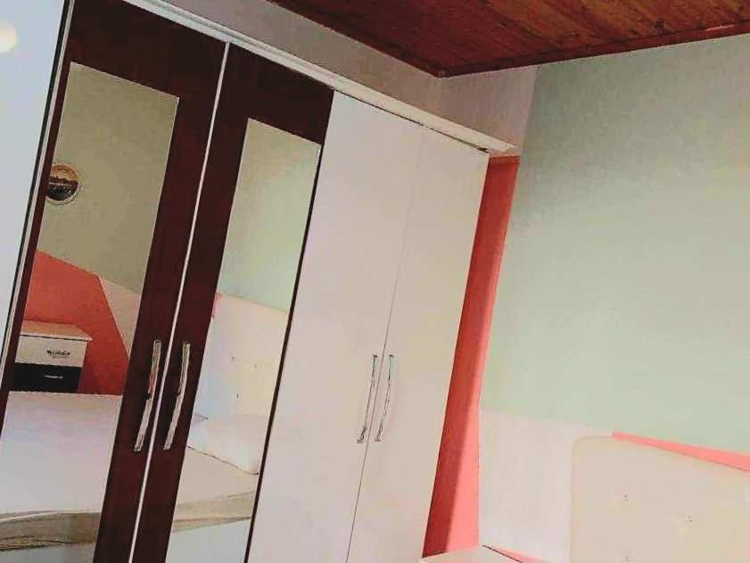 a white cabinet in a room with a ceiling at Stairway to heaven in Shkodër