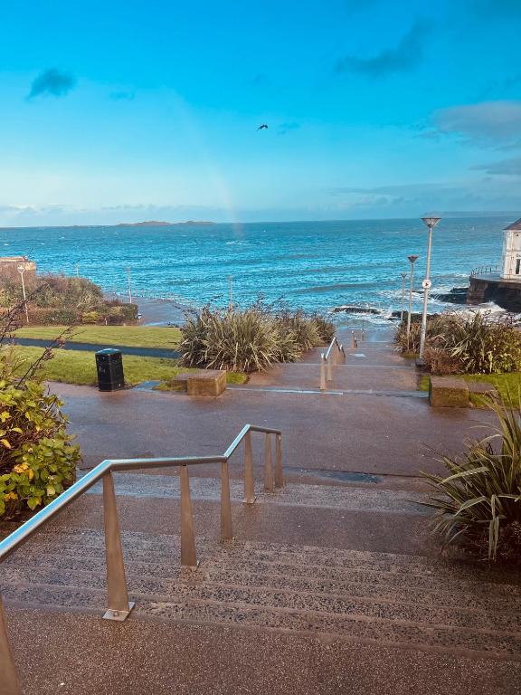 a walkway leading to a beach with the ocean at Albany Lodge in Portrush