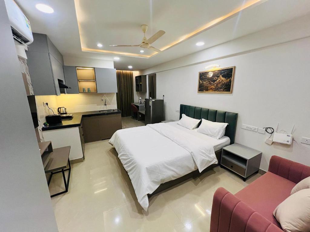 a hotel room with a bed and a kitchen at The Sleepy Monkey in Jaipur