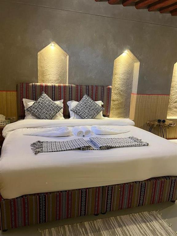 Postel nebo postele na pokoji v ubytování Al Jalilain Inn