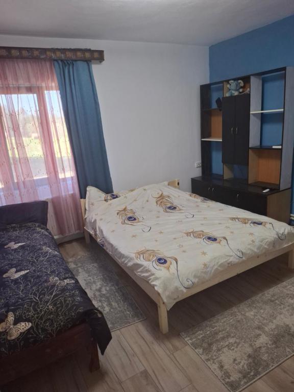 Ένα ή περισσότερα κρεβάτια σε δωμάτιο στο Cabana Mădălin&George