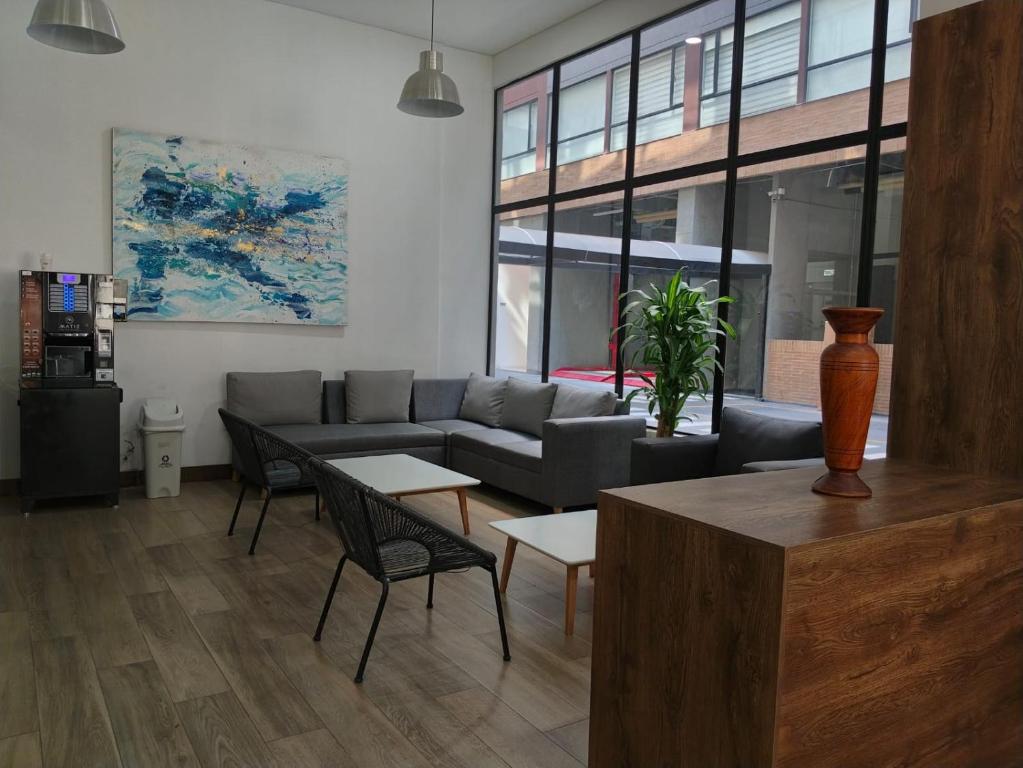 a living room with a couch and a table at Suite con piscina in Bogotá