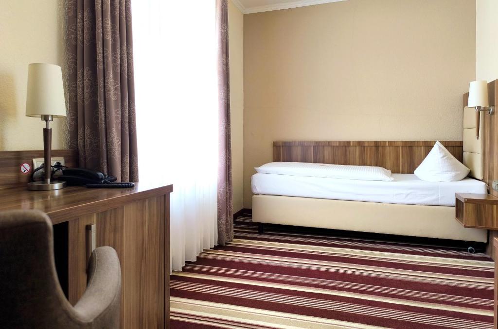 Postel nebo postele na pokoji v ubytování Hotel Burgas