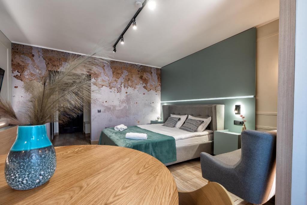 een slaapkamer met een bed, een tafel en stoelen bij Marcos Studio Nice and Cozy in Piteşti