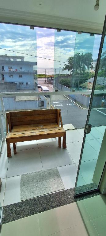 ナヴェガンテスにあるSuíte, 50m praia, 12km Beto Carrero e BCの木製のベンチ