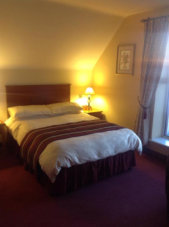 Postel nebo postele na pokoji v ubytování Fitzgeralds Hotel