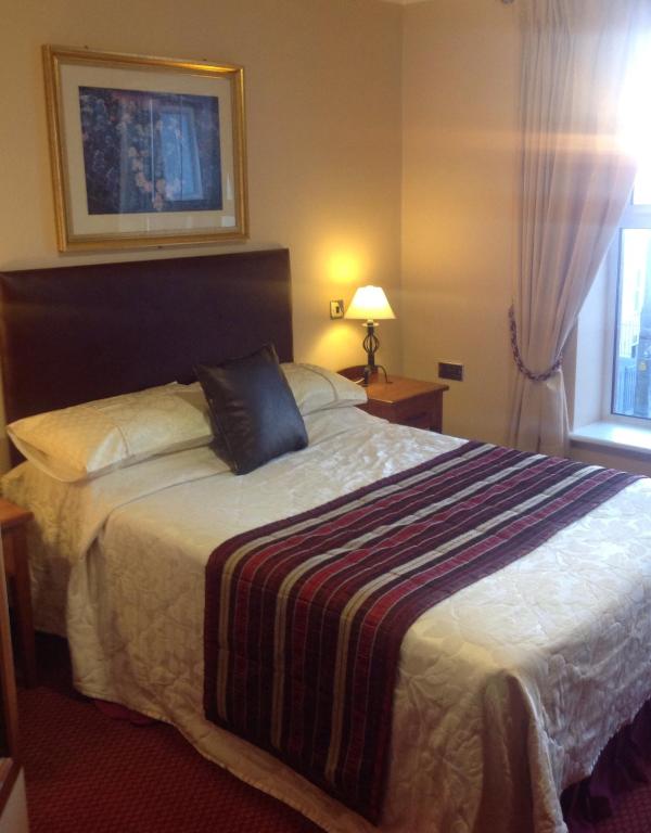 Postel nebo postele na pokoji v ubytování Fitzgeralds Hotel
