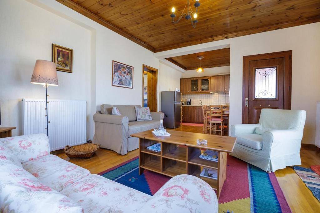 a living room with a couch and a table at Holiday house Elliniko Arcadia in Elliniko