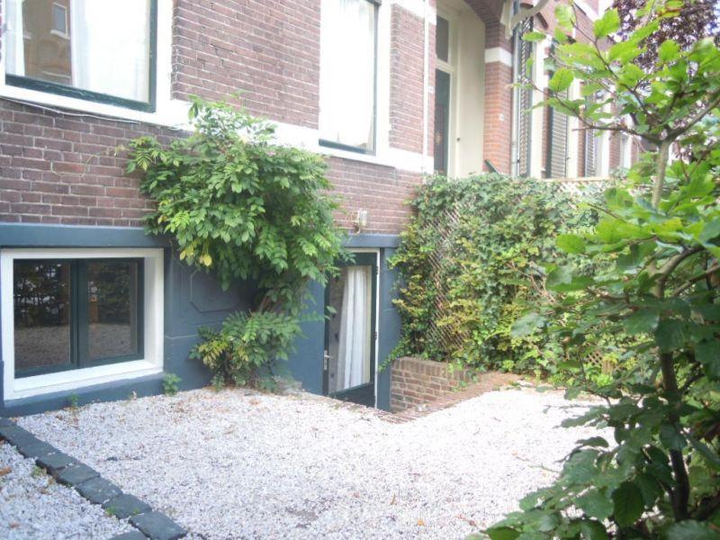 a brick house with a blue door in front of it at Cosy appartment in Arnhem