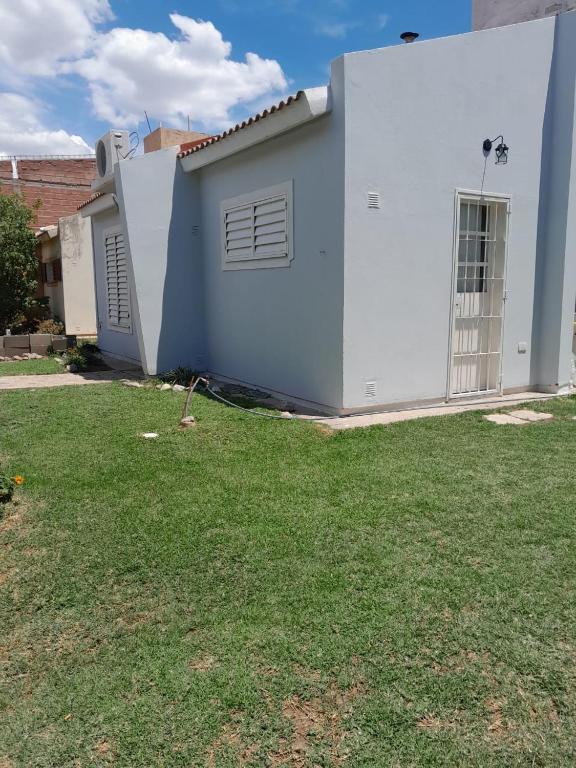 a white house with a yard in front of it at Casa en La Punta San Luis in La Punta