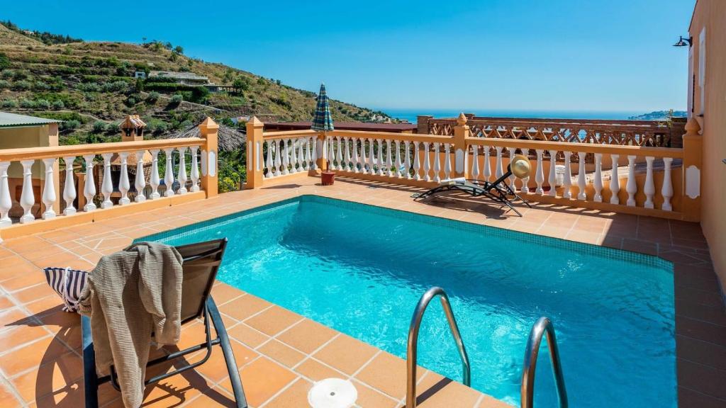 a swimming pool on a deck with a balcony at Gonzalez Almuñécar by Ruralidays in Almuñécar