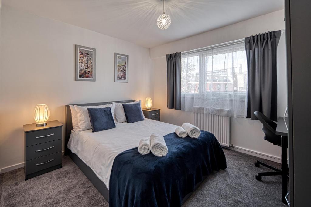 a bedroom with a bed with shoes on it at Central Nottingham 3 bed house with Driveway in Nottingham