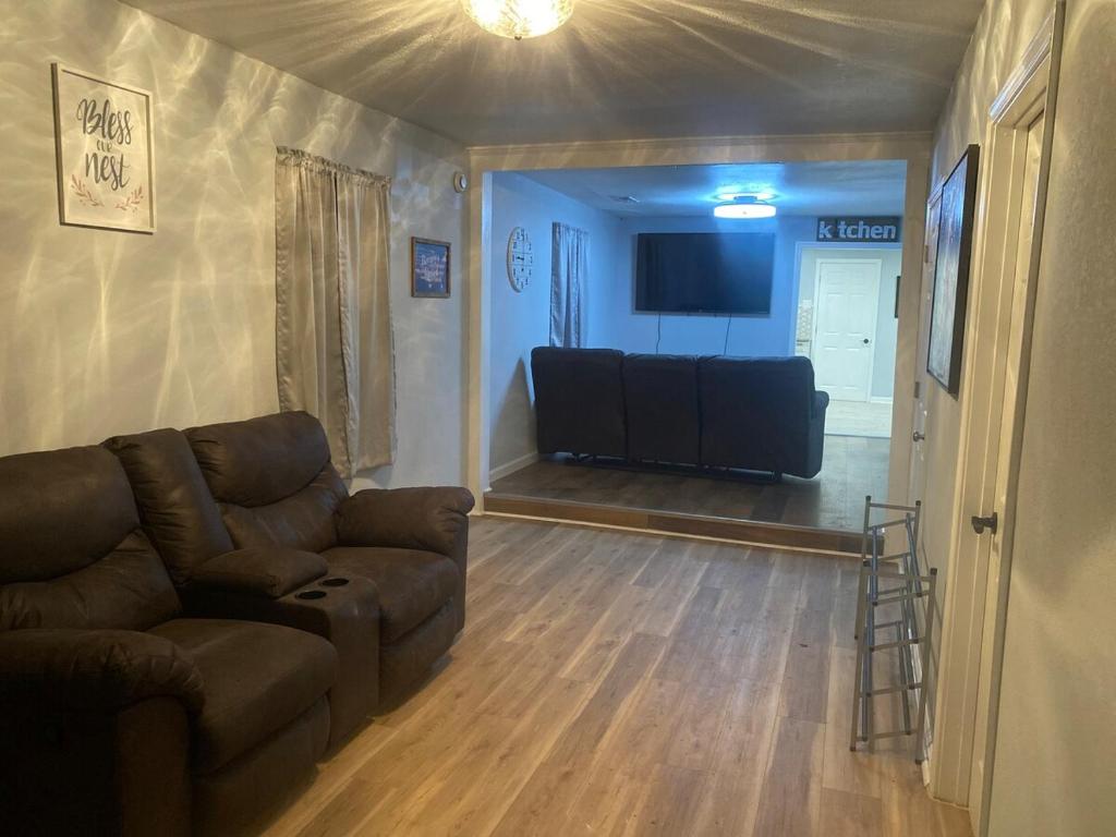 a living room with a couch and a flat screen tv at Spacious 3 Bedroom , 1 Bath House Pet friendly in Red Top