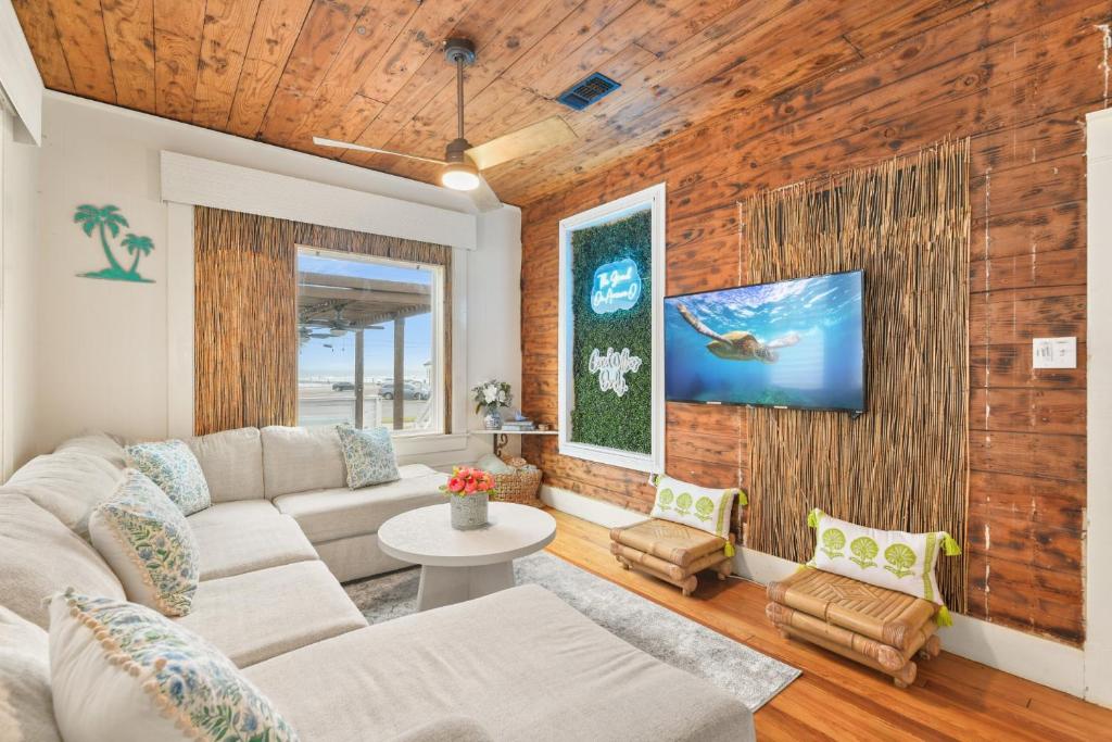 a living room with a couch and a table at The Grand on Ave O in Galveston