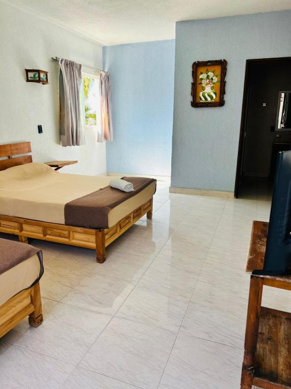 Postel nebo postele na pokoji v ubytování Hotel en Tequesquitengo