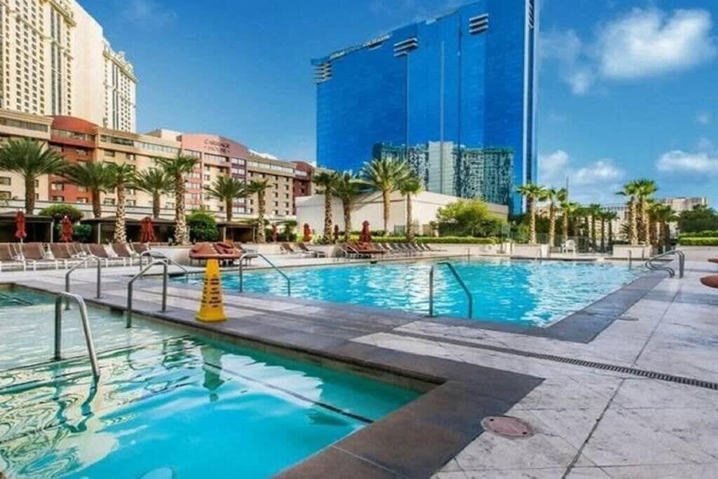 a large swimming pool in a city with buildings at MGM 1BR Mountain View Balcony 28802 in Las Vegas