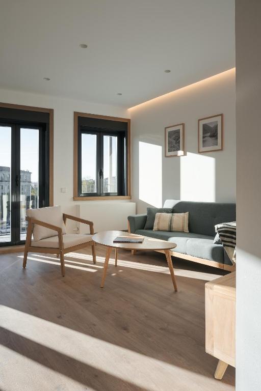 a living room with a couch and a coffee table at Avós Apartamentos in Monforte de Lemos