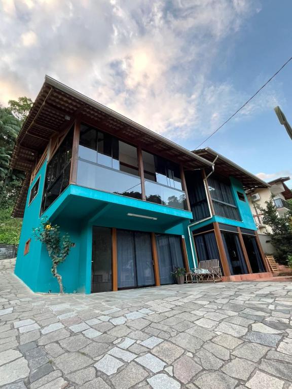 a house with a blue facade at Suite Familia B2 in Pomerode