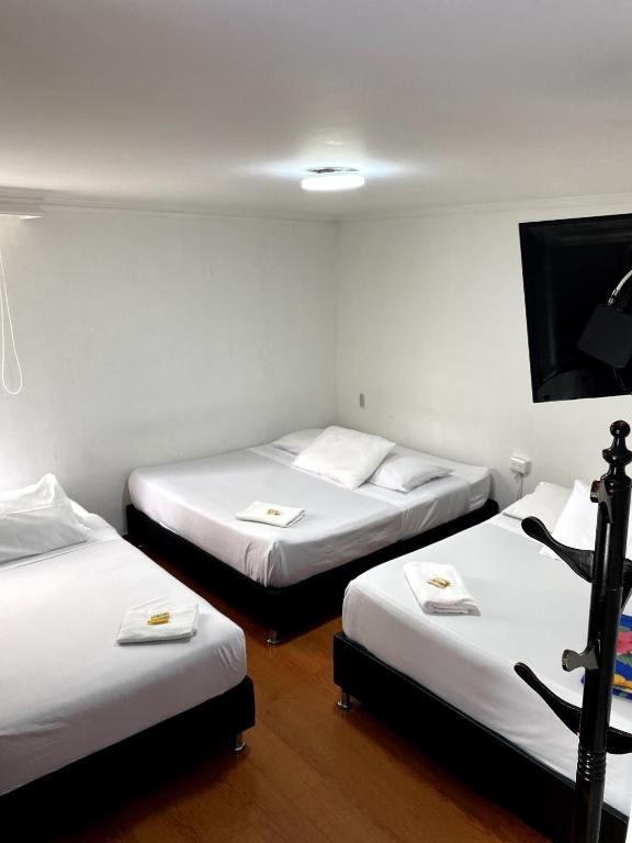 Postel nebo postele na pokoji v ubytování Hotel Quintas de Bogotá