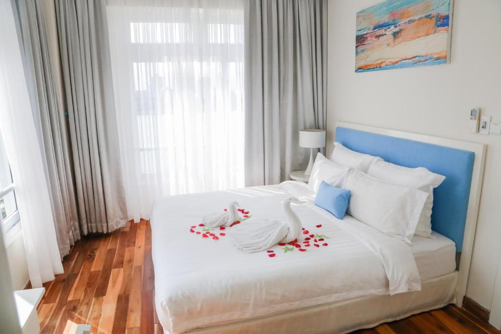 Postel nebo postele na pokoji v ubytování Palmier Hotel - Art House Da Nang