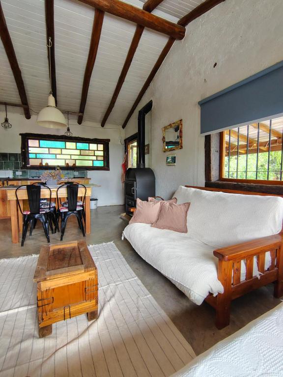 a living room with a couch and a table at VILLA ESPINA CHALET DE MONTAÑA a 8 km de San Javier in Villa de Las Rosas