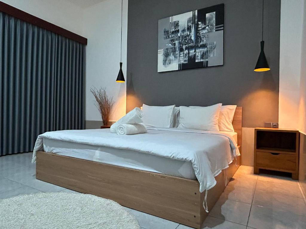 Postel nebo postele na pokoji v ubytování Sayang Bungalows