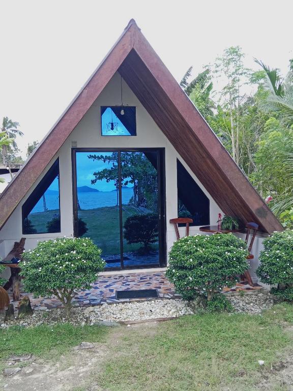 a small house with a large window in the yard at Villa Fria private beach cottage in San Vicente