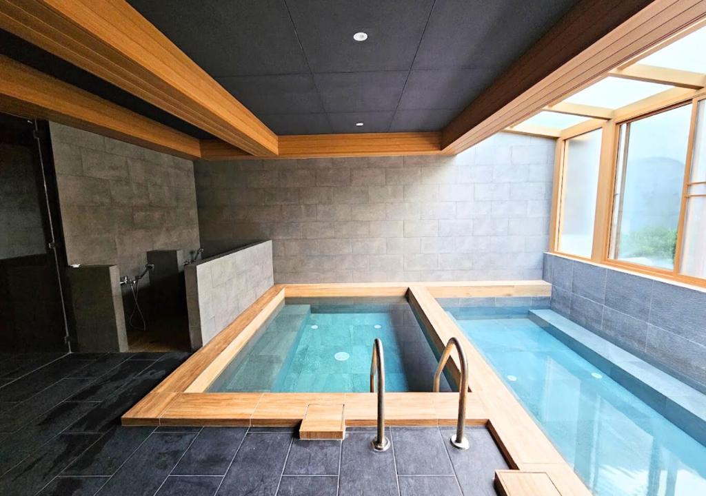 a large swimming pool in a house at Zen Next Khao Yai By ZV in Pak Chong