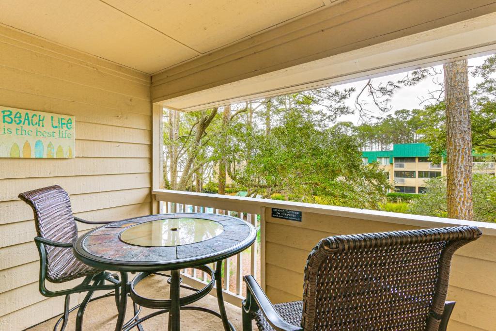 a porch with a table and chairs and a window at Beach and Pool Access Tranquil Hilton Head Getaway in Hilton Head Island