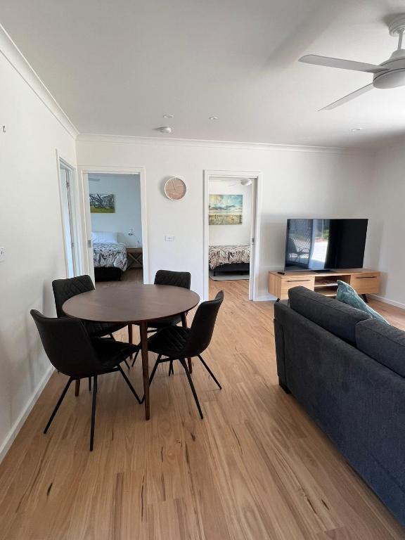 a living room with a table and chairs and a couch at Willow Dene Holiday Apartments in Bright