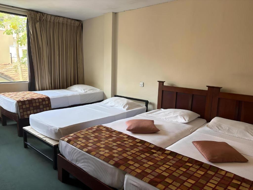 Postel nebo postele na pokoji v ubytování Hotel Janaki