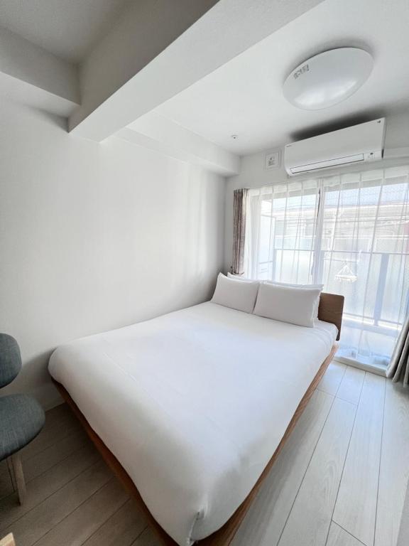 Postel nebo postele na pokoji v ubytování Real Okubo Apartment Hotel