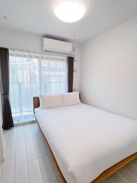 Postel nebo postele na pokoji v ubytování Real Okubo Apartment Hotel