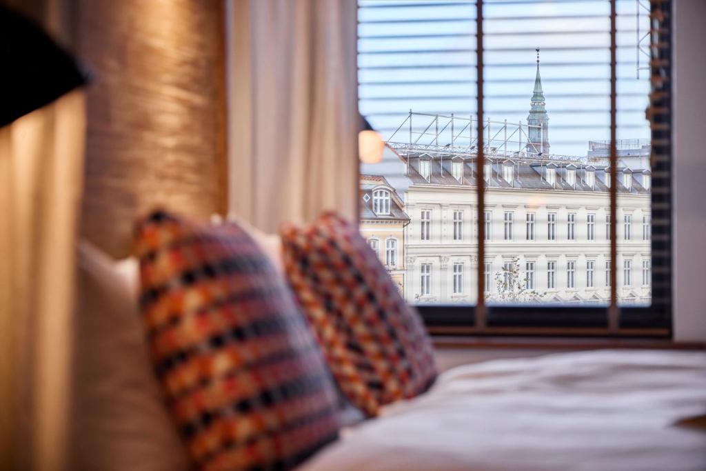 Postel nebo postele na pokoji v ubytování Manon Les Suites Guldsmeden